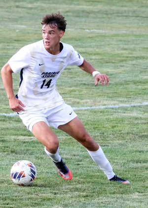 Liam McLean playing soccer in white UIS jersey