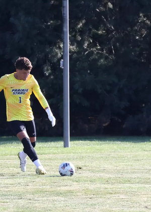 UIS goalkeeper Kevin Kardel kicks ball, yellow jersey