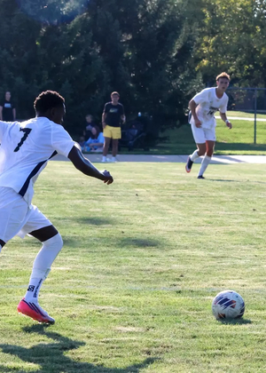 Gentil Selemani bringing ball up field in a UIS soccer game