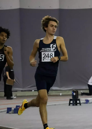 Charlie Borlin running indoor track at GLVC Championships
