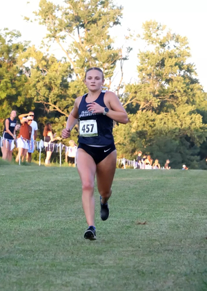 Marissa Roggensack running cross country in UIS blue