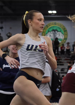 Maddie Miller racing mile in indoor track