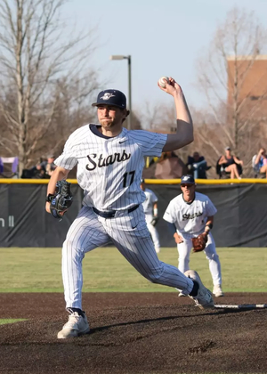 Graham Kasey pitching in white UIS uniform