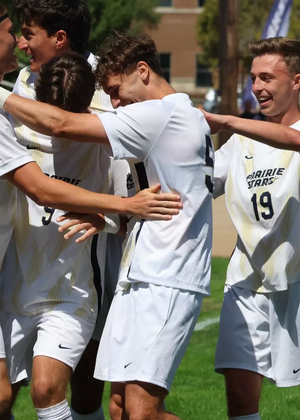 UIS men's soccer athletes in white UIS uniforms celebrate a goal
