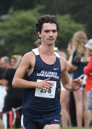 Joey Karlesky running cross country in blue UIS uniform
