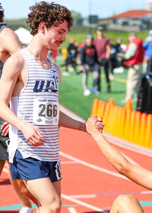 Joey Karlesky helps up teammate Matt Padilla after race