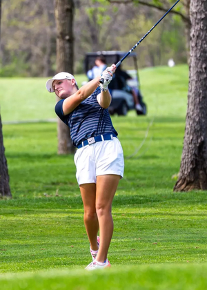 Elaine Grant golfing in UIS blue and white at GLVC Championship