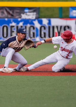 Noah Caceres playing second base in gold baseball uniform
