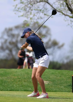 Elaine Grant golfing in blue UIS polo and hat