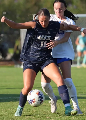 Alaina Stock playing soccer in blue UIS uniform