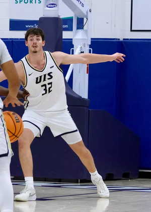 Alex Stell playing basketball at UIS