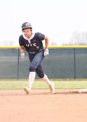 Bailey Masching baserunning in blue UIS softball uniform