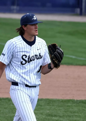 Ben Benoit pitching in white UIS baseball uniform