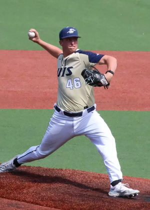 Brayden Mayer pitching for UIS baseball in gold uniform