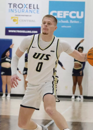 Brit Dutton playing basketball at UIS