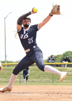 Calista Stahlhut pitching in blue UIS uniform