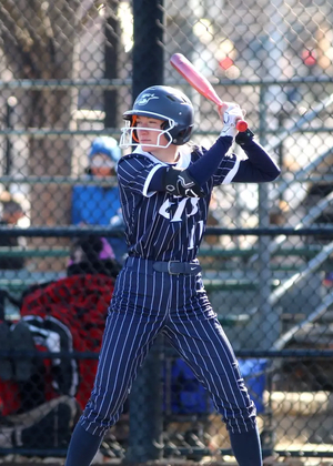 Chloe Scroggins playing softball in blue UIS uniform