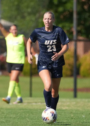 Abby Roy playing soccer in blue UIS uniform