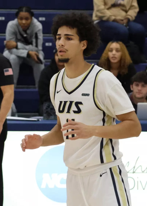 Donaven Younger playing basketball in white UIS uniform
