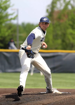 Graham Kasey pitching in white UIS uniform