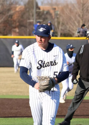 Austin Loberger pitching in white UIS uniform