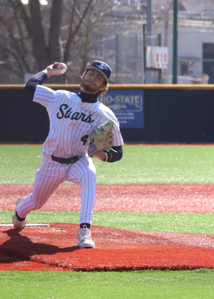 Trey Carter pitching in white UIS baseball uniform