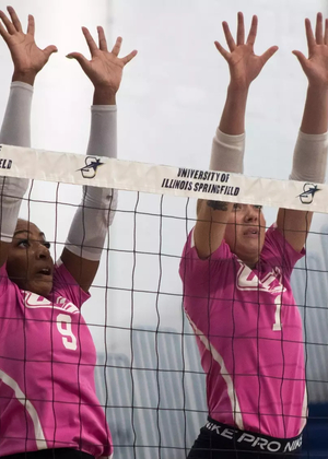 UIS volleyball block, pink jerseys