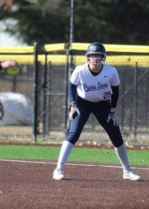Calista Stahlhut on first base in white UIS uniform