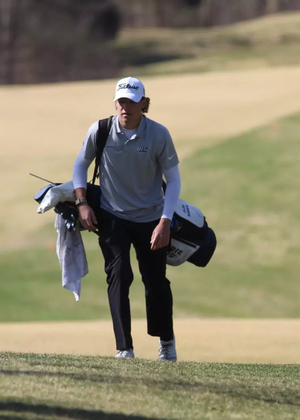Julien Babineau with his golf clubs