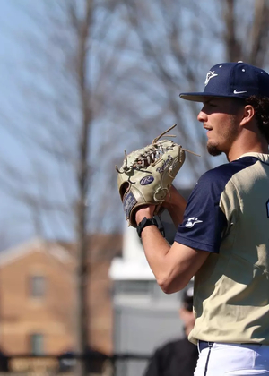 Richie Snider pitching in gold UIS uniform
