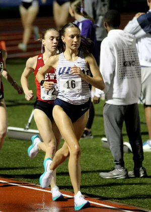 Maddie Miller running outdoor track in UIS uniform