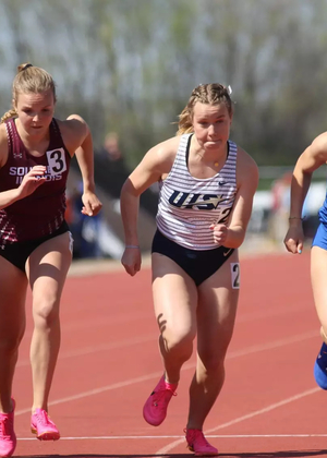 Camille Terre racing off starting line in outdoor track