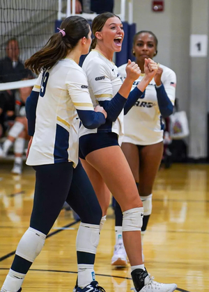 Carly Michels, Makenna Cox, and Erica Sledge celebrate scoring a point