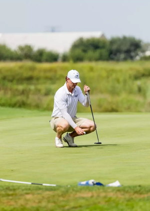 Jacob LeBlanc golfing in white UIS polo and hat