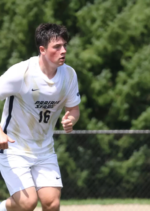 Jacob Shaw playing soccer in white UIS uniform
