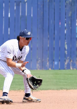 Jesse Contreras playing shortstop in white UIS baseball uniform