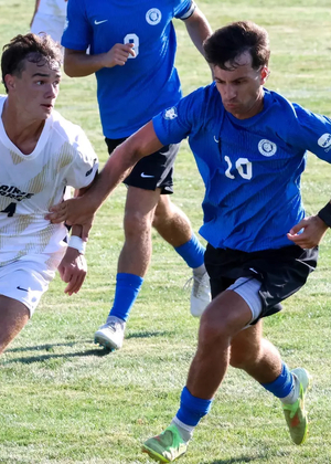 Liam McLean playing soccer at UIS in white Prairie Stars jersey