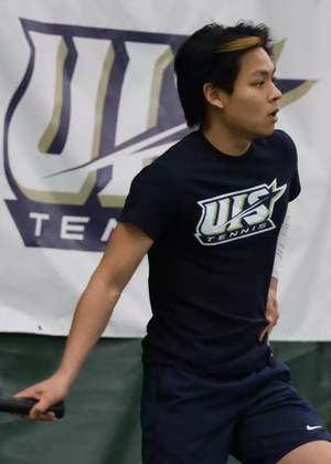 LIN EN TAN PLAYING TENNIS, FEATURING UIS TENNIS BANNER