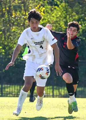 Rafael Pacino playing soccer in white UIS uniform