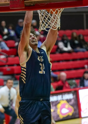 Alex Stell dunking a basketball at UMSL