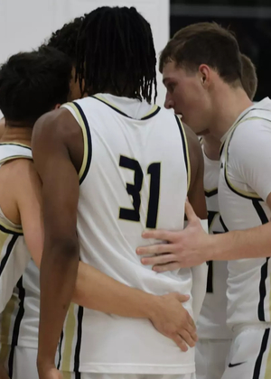 men's basketball team huddle