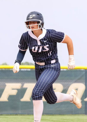 Rachel McMullen running the bases in blue UIS softball uniform