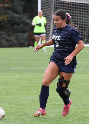 Reese Lowery playing soccer in blue UIS uniform