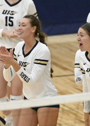 UIS bench celebrating at a volleyball  match
