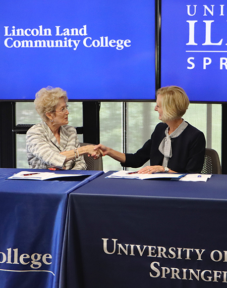 LLCC President Charlotte Warren and UIS Chancellor Janet Gooch shake hands