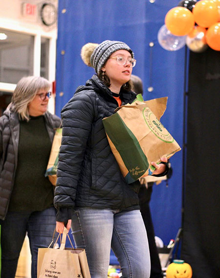 Student holding bags of food
