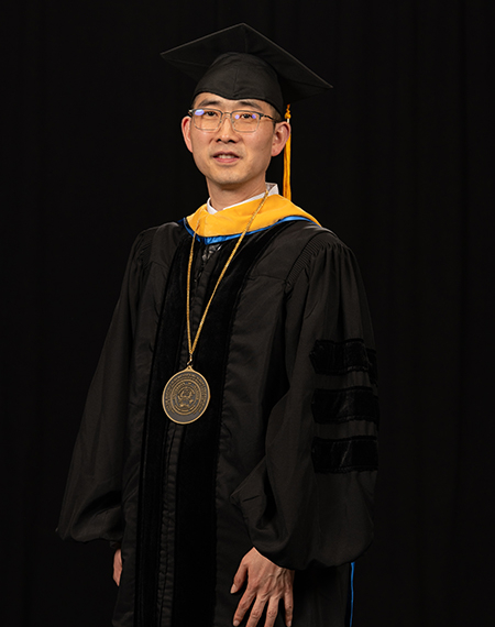 Yanhui Guo stands in regalia during his Ceremony of Investiture.