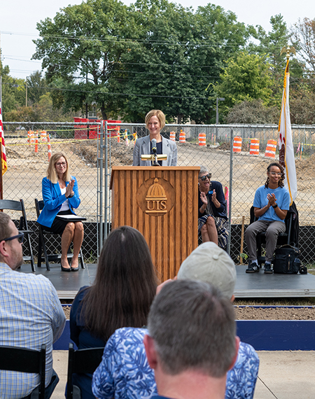 Chancellor Janet Gooch speaks at a podium during the UIS Library Commons groundbreaking ceremony.