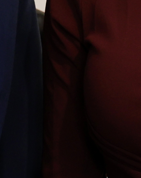 Two women smiling with an award certificate in a professional setting.