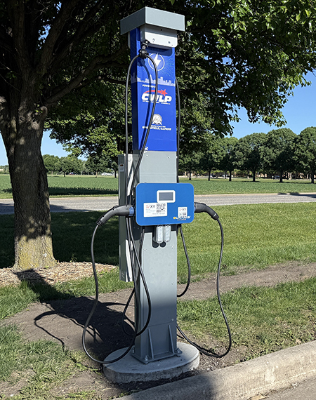 Electric vehicle charging station in a park setting.